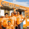 Five women smiling in front of the Carla's Food food truck